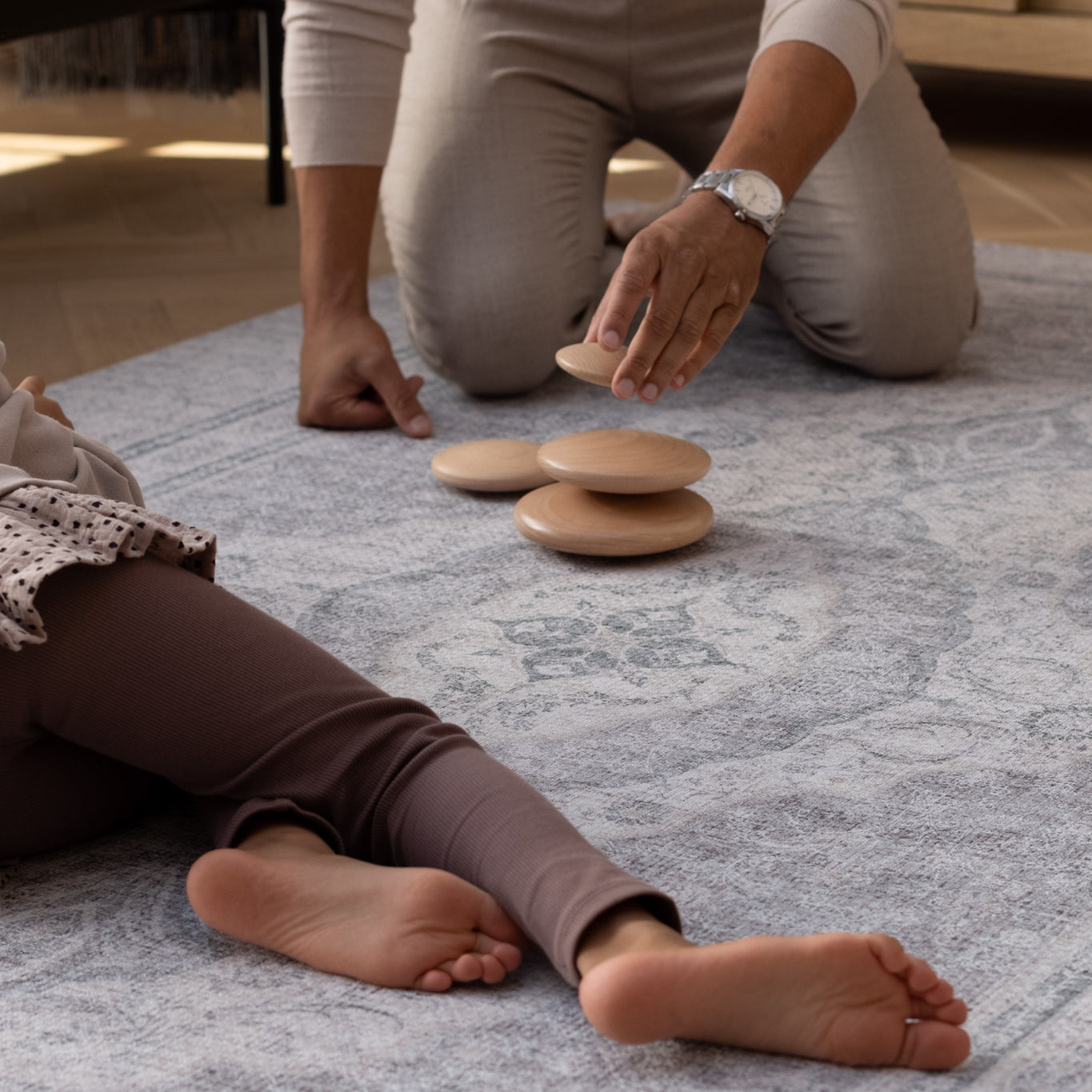 dad and child play on an elegant play mat rug