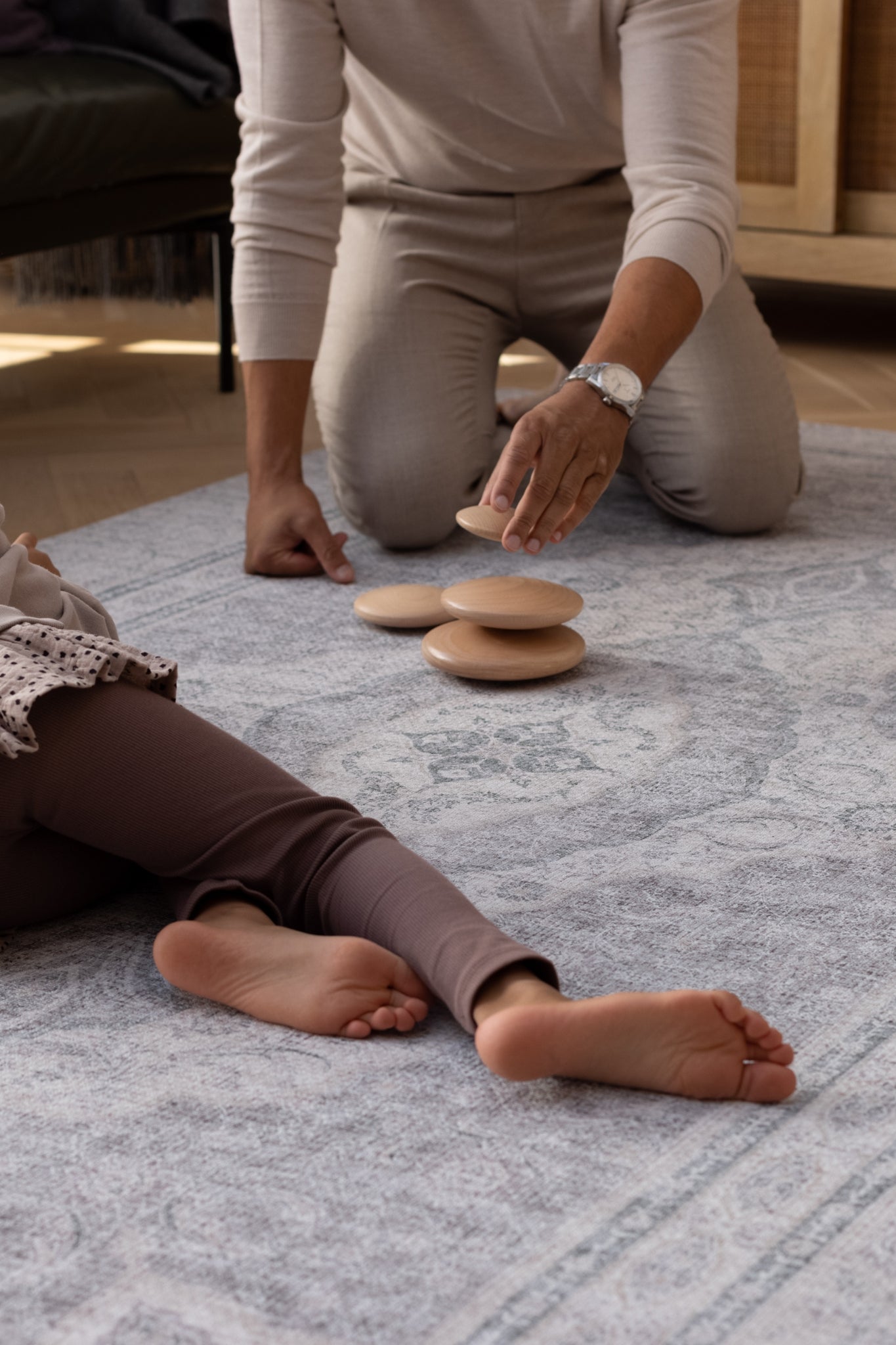 dad and child play on an elegant play mat rug