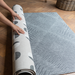 Hands unroll the astronomer and eclipse monochrome play mat with a memory foam design that can be enjoyed on both sides