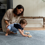 Lady and child enjoy floor time in comfort on grey play rug designed from birth with safe non toxic materials