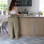 Lady standing on Kitchen runner by Totter and Tumble provides support for joints in the kitchen and can be used as an exercise with stylish design the whole family will love 