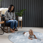 Large round play mat by Totter and Tumble acts like a wipeable area rug in the family home easy to clean spit up and spillages and looks stylish