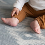 Close up of surface and babies feet on Padded baby play mat that the whole family will love The Atlas is available in four sizes so you can choose the perfect size for your family space