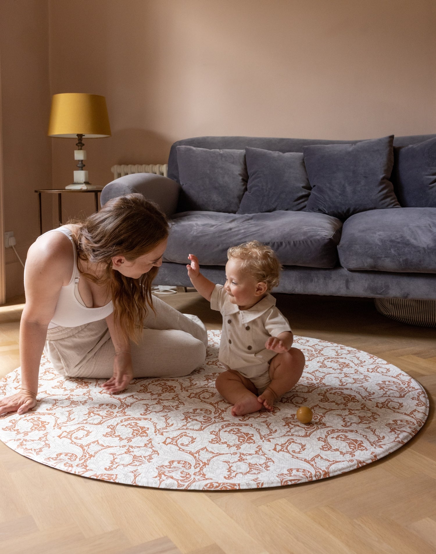 mum and baby playtime on round elegant Morris play mat from totter and tumble in stylish living room