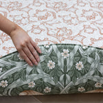 person showing the reversible design on red William Morris play mat