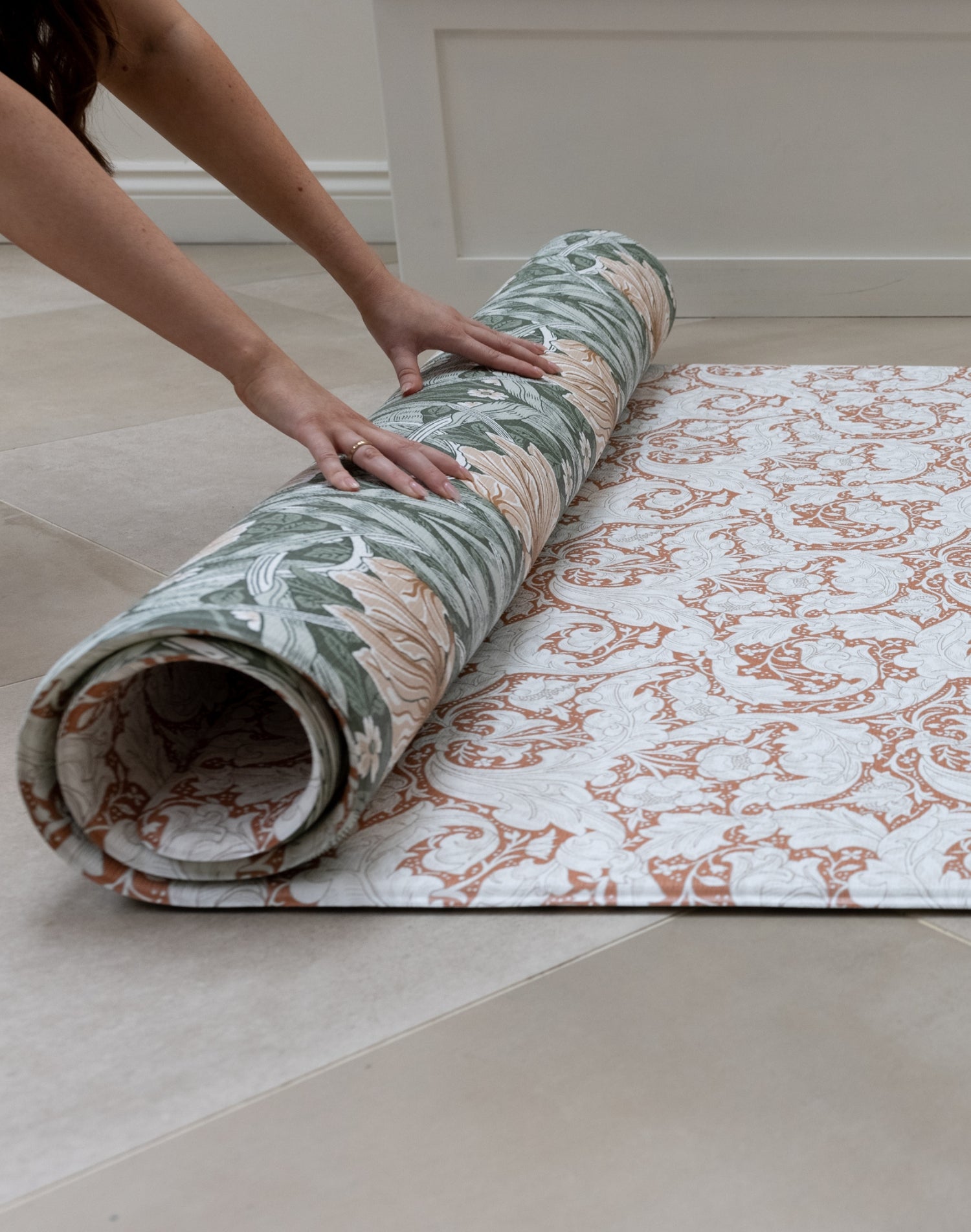 elegant totter and tumble play mat being rolled out on floor