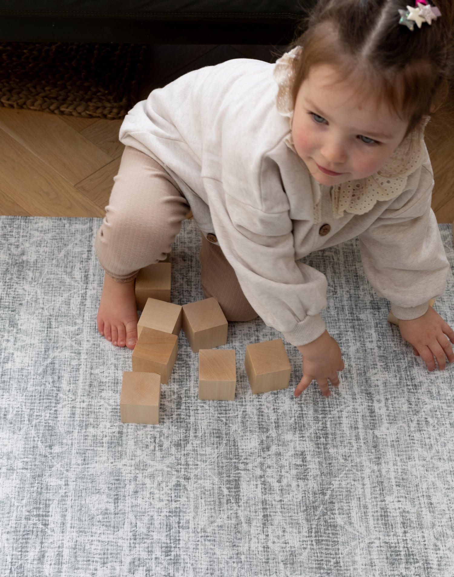 toddler plays on large padded play mat