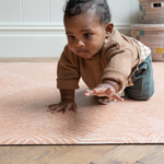 Baby crawls on soft play mat with. thick memory foam design that adds protection on the floor