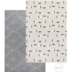 Tan play mat with eclipse inspired motif with a dark grey play mat on the reverse featuring a textile kilim design easy to flip from one side to the other so you can change your interior style simply 