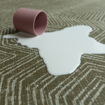 Milk spills on washable baby play mat practical for family homes