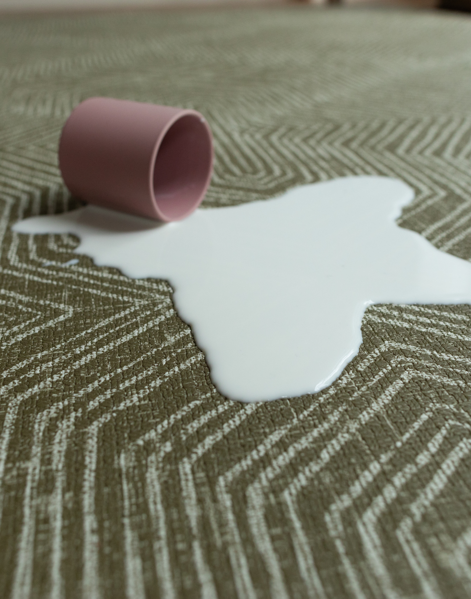 Milk spills on washable baby play mat practical for family homes