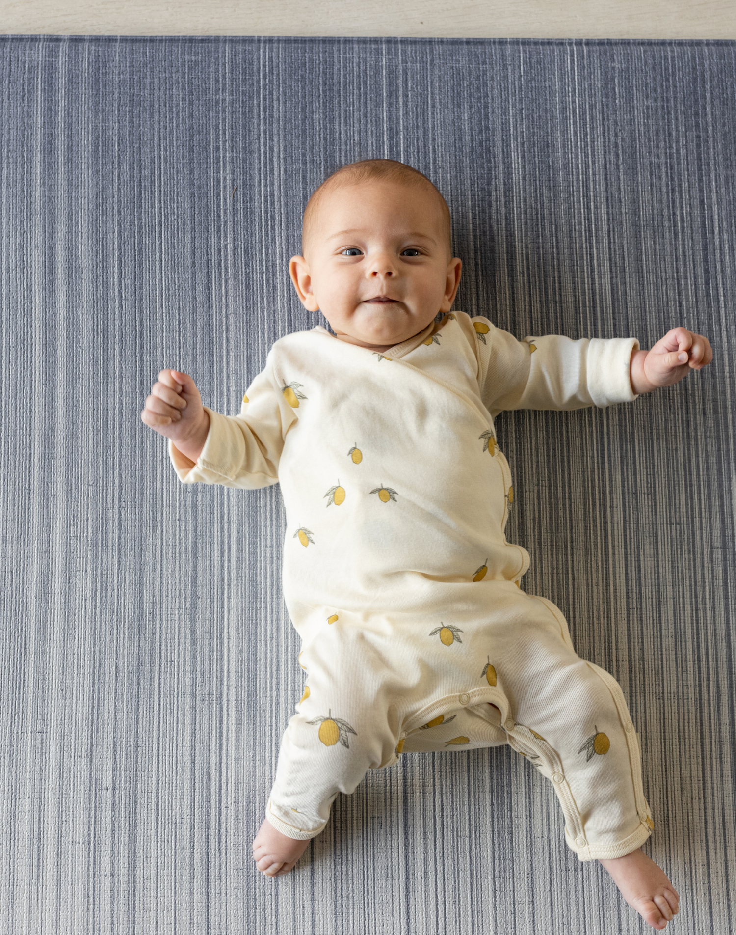 Cute baby laying on Ombre blue baby play mat made for support on the floor perfect for tummy time and playing stylish design looks great in modern interiors 