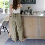 Lady stands supported on Thick foam runner in the kitchen is ideal as an anti fatigue mat to make household chores easier also ideal as an exercise mat anywhere in the home with the stylish navy blue ombre design