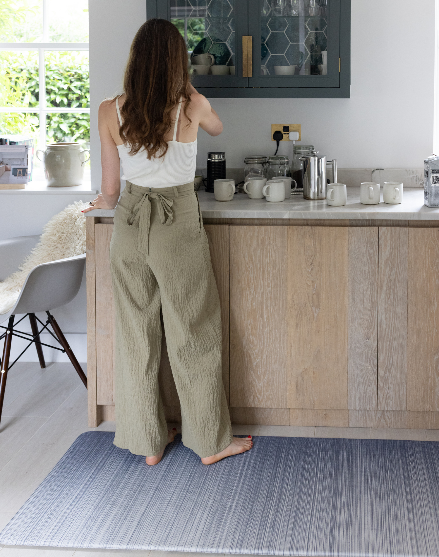 Lady stands supported on Thick foam runner in the kitchen is ideal as an anti fatigue mat to make household chores easier also ideal as an exercise mat anywhere in the home with the stylish navy blue ombre design