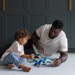 Adult and child enjoying floor play together kept comfortable by Totter and Tumble play mat made with cushiony memory foam for better support