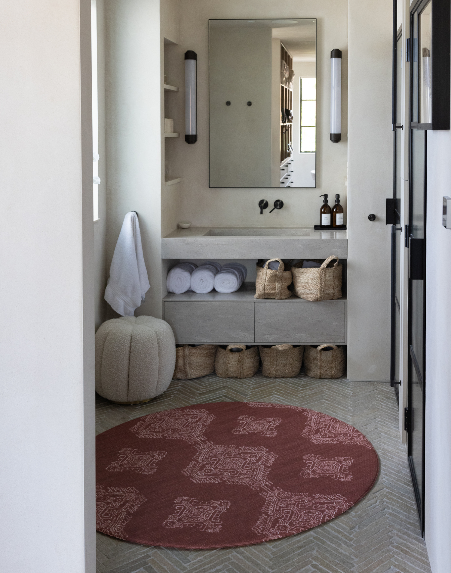 Beautiful large round bathroom mat in a textural red design to complement modern styling and bathroom hardware with a wipeable surface so water can be wiped away and a memory foam surface to ensure babies are comfy during changing 