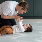 Mom and baby on Large round tumble mat by Totter and Tumble with modern ikat design to look like a rug in your home