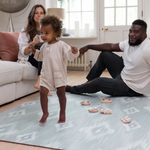 Mom, dad and toddler enjoy Baby play mat made for the whole family totter and tumble play mats are safe from birth and are perfect for the whole family to use