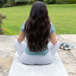 Lady sits on Thick play runner ideal as a standing mat exercise mat and runner in the home made from mouldable memory foam to give support and comfort wherver you use it 