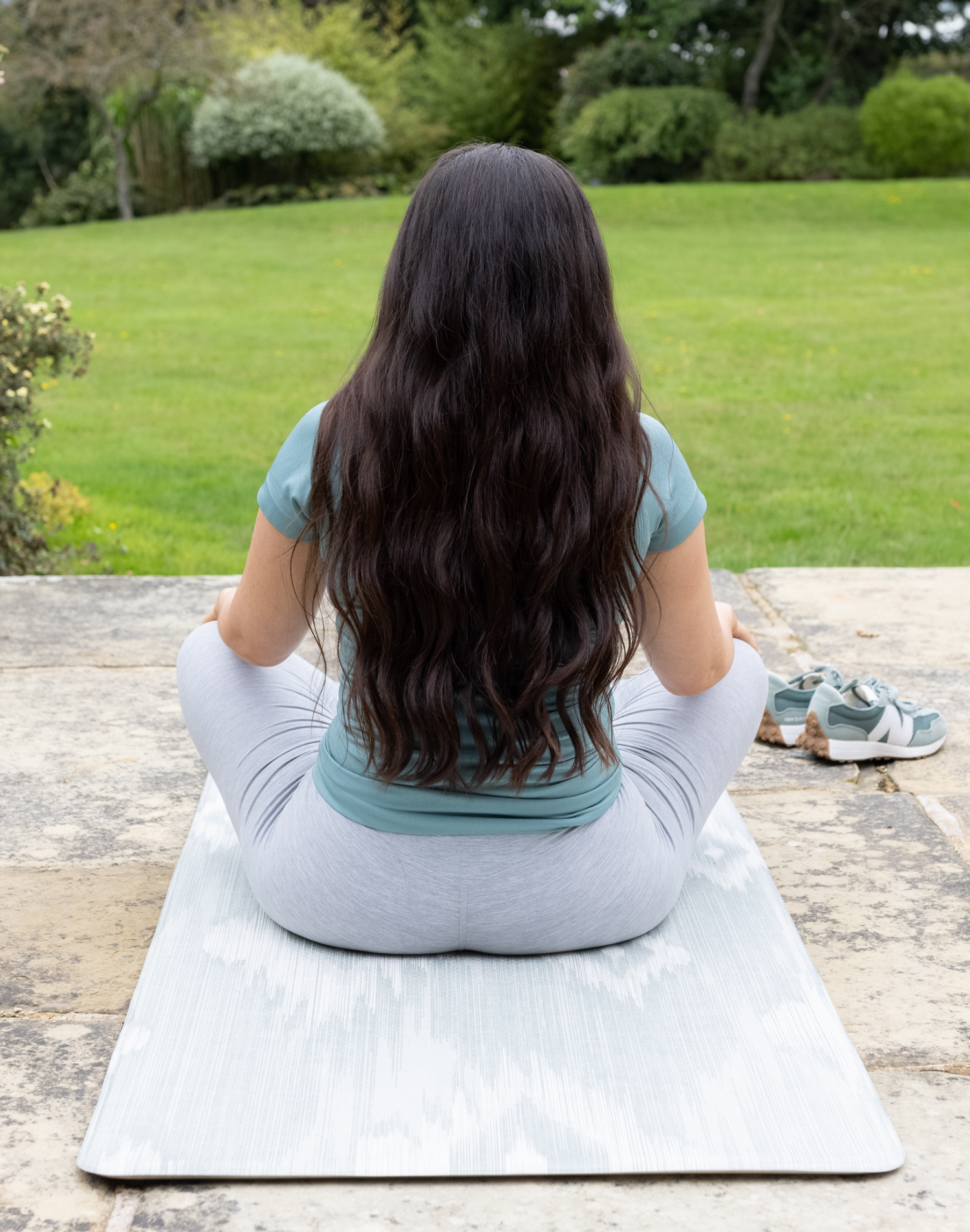 Lady sits on Thick play runner ideal as a standing mat exercise mat and runner in the home made from mouldable memory foam to give support and comfort wherver you use it 