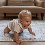 crawling baby on stylish William Morris play mat