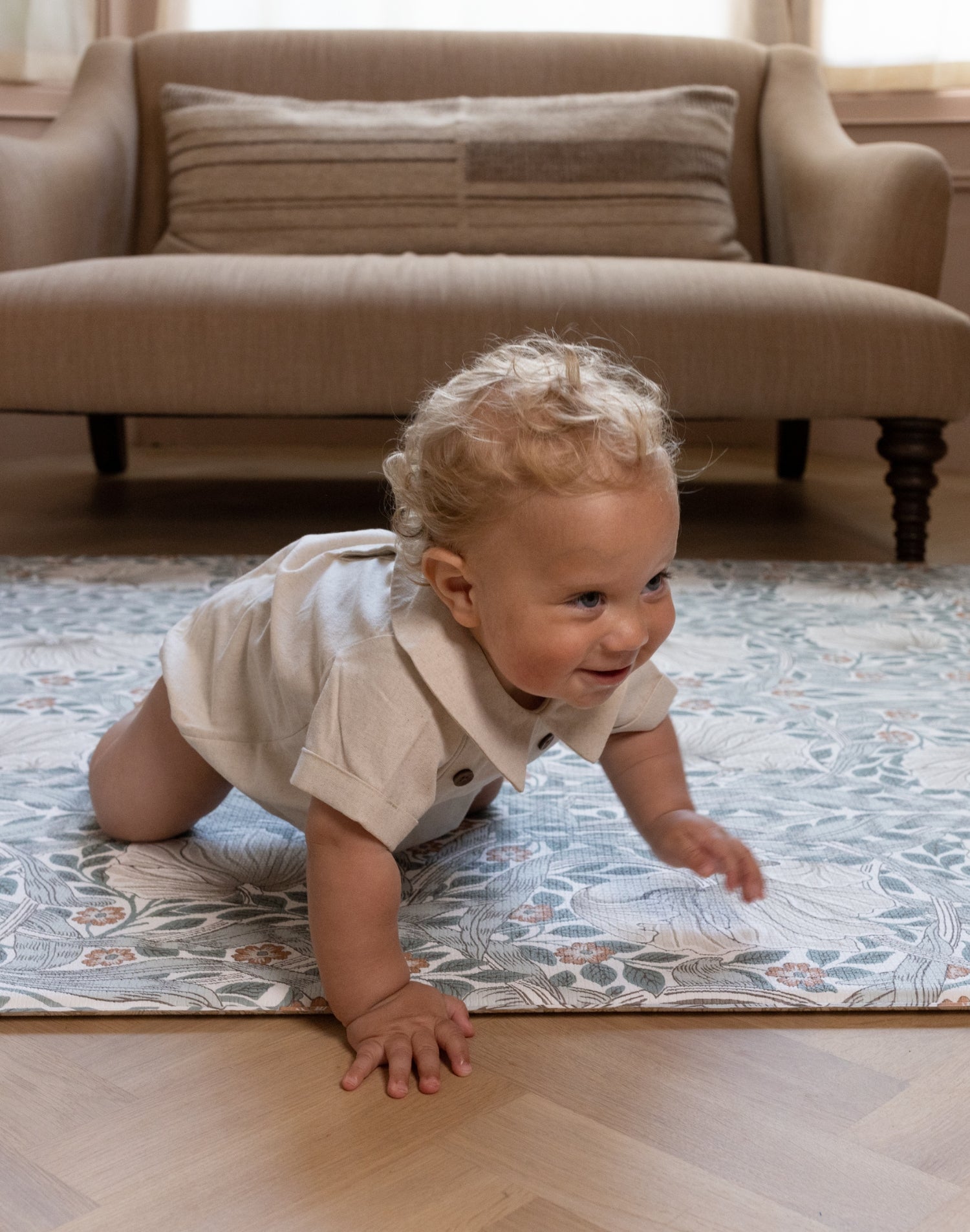 crawling baby on stylish William Morris play mat