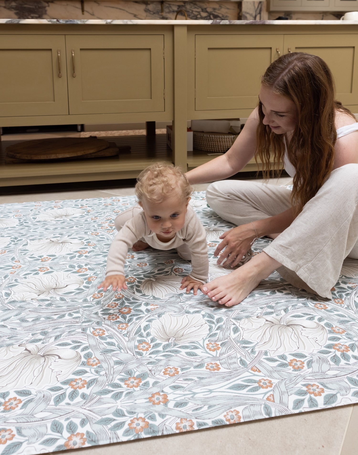 parent and child enjoying kitchen play mat