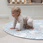 baby crawling on round pimpernel play mat