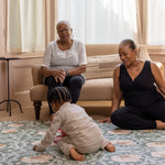 grandparents playing with toddler on comfy and stylish play mat
