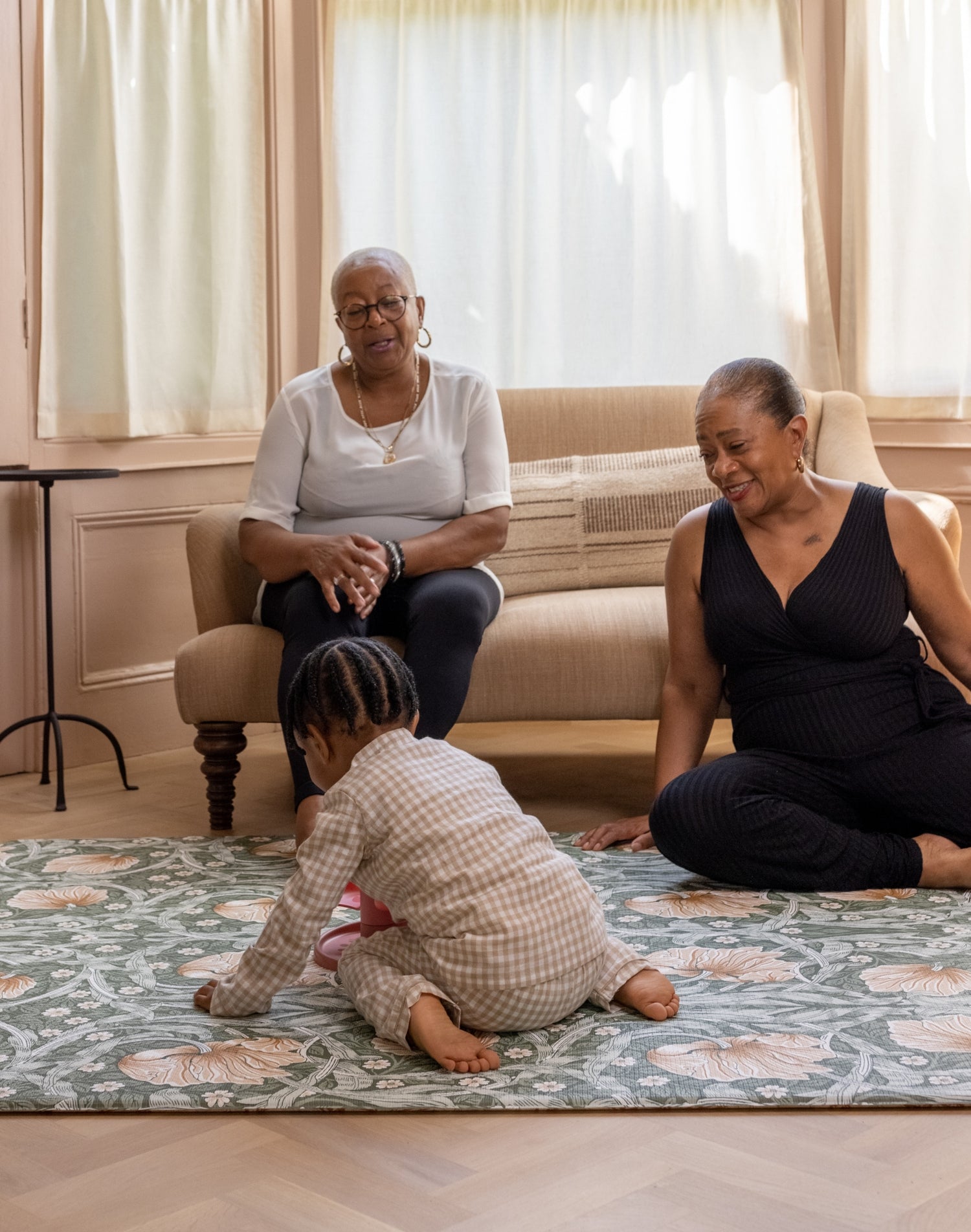 grandparents playing with toddler on comfy and stylish play mat
