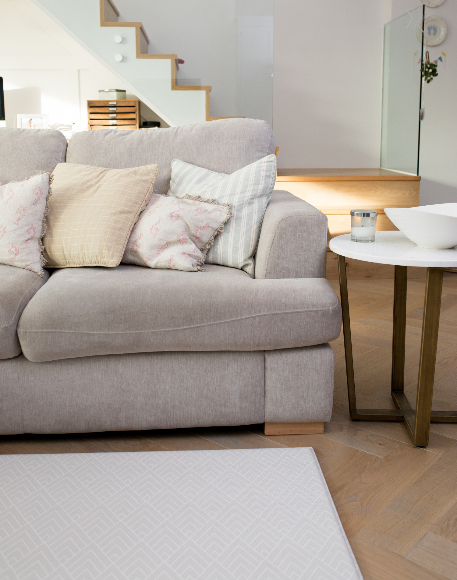 Stylish living space with a subtly designed play mat placed by the sofa for the whole family to live more comfortably