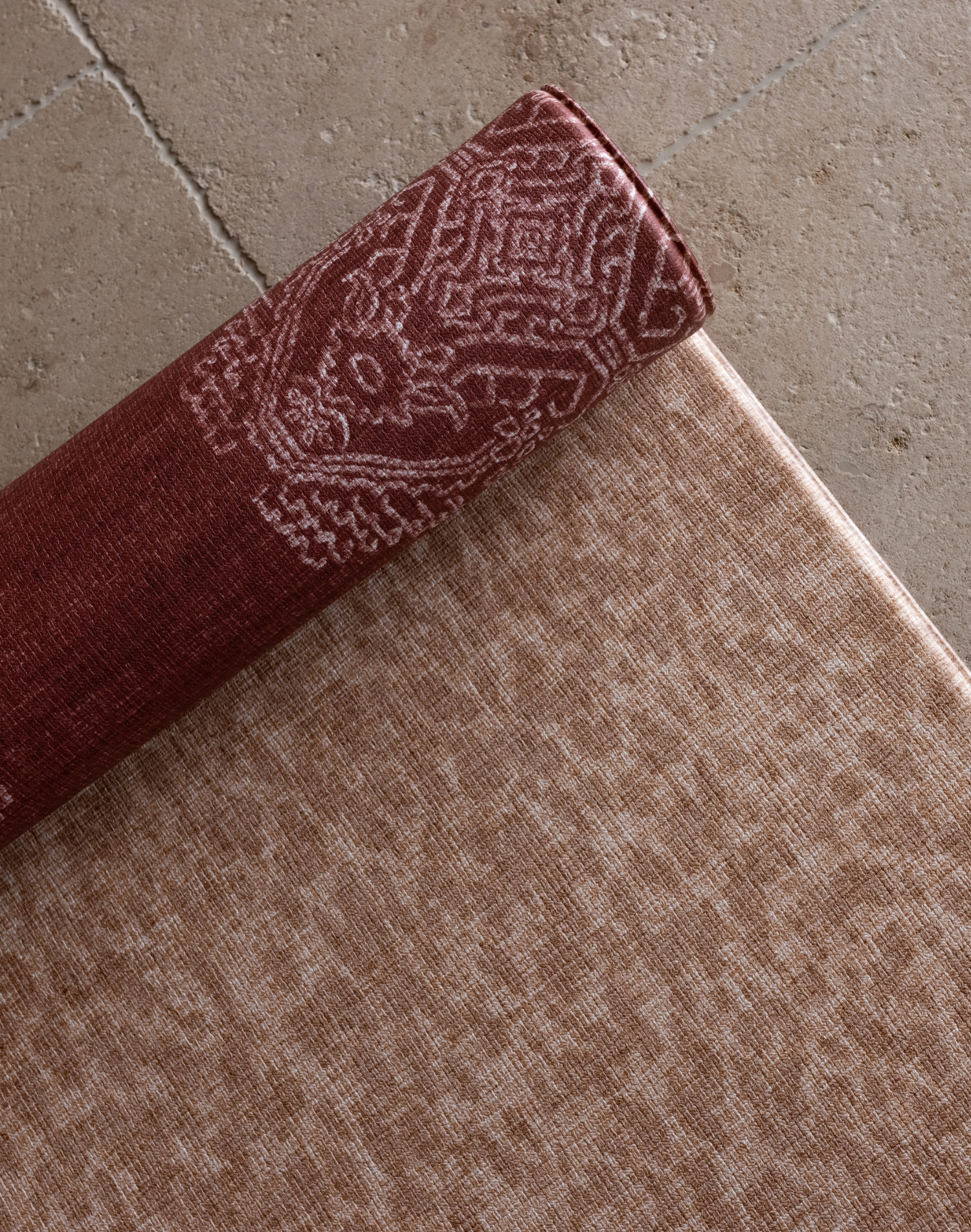 Close up of the textural Rusa play mat with the beautiful garnet red Merah on the reverse made to be safe from birth and ideal for providing ultimate protection on all types of flooring in the home 