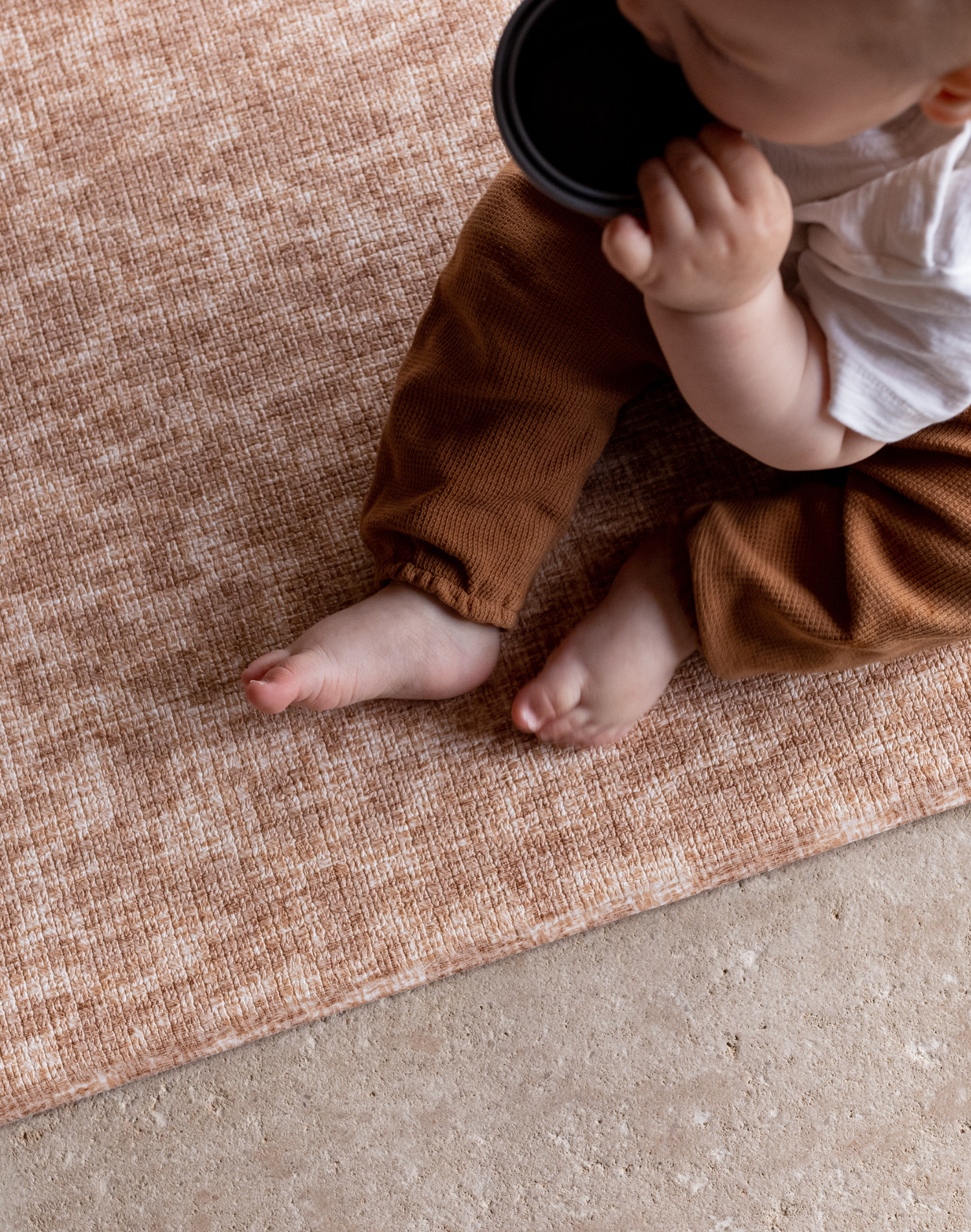 Baby sits unaided and comfortable on the subtle leopard print play mat with a jute texture for a subtle look thick memory foam supports and protects from any falls and tumbles on hard flooring