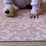 Baby is supported on the thick memory foam surface of the animal print Rusa play mat with cushy memory foam to keep little ones protected and safe on the floor 