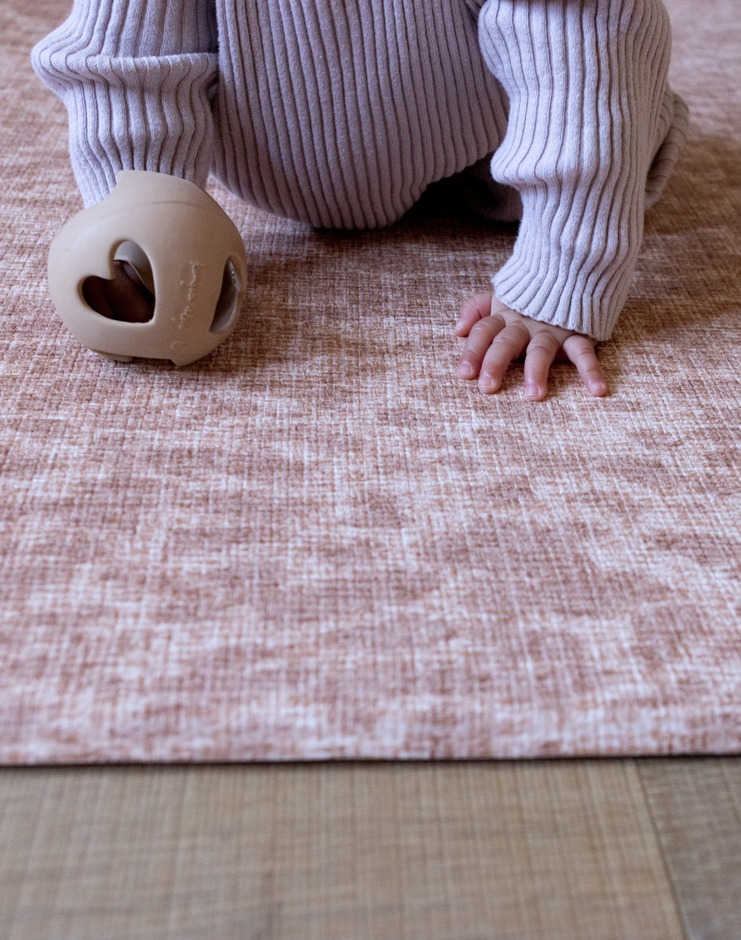 Baby is supported on the thick memory foam surface of the animal print Rusa play mat with cushy memory foam to keep little ones protected and safe on the floor 