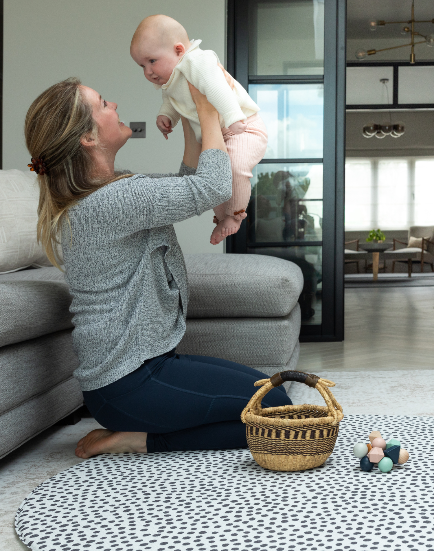 mom and baby are playing on the jumbo round kids play mat with the insta famous scout design