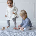 Toddlers are kept safe on the ergo foam play mat made from non toxic materials and thickly padded