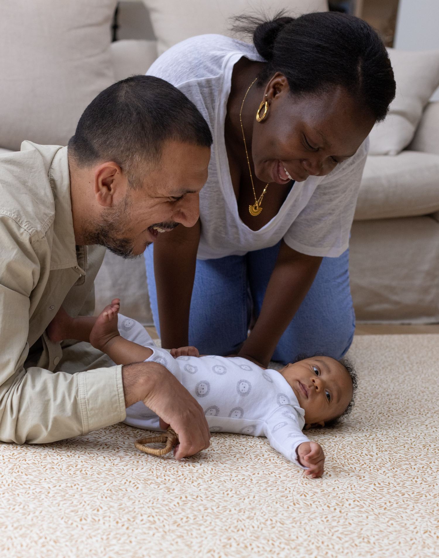 mom and dad on totter and tumble play mat with newborn baby. supportive and sized for the whole family in morris & co botanical standen print Baby floor mat, two-sided, memory-foam play rugs