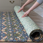 Unrolling double sided play mat with Strawberry Thief and Willow Boughs designs both from William Morris archive simple to flip from one side to the other perfect play mat for family homes