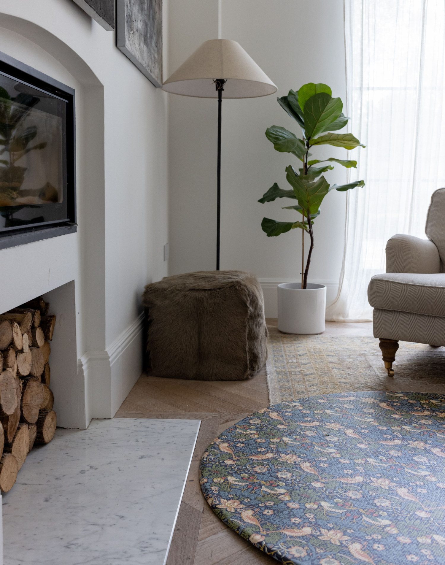 Stylish family interior with round baby play mat by Totter and Tumble featuring iconic Strawberry Thief design from the William Morris archives