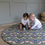 Adorable babies playing on round Totter and Tumble play mat with stacking cups enough space for fun play mats on the one-piece memory foam design