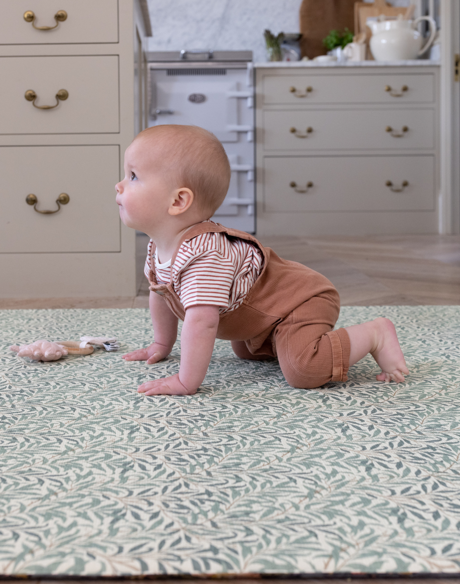 Baby in crawling stance on Morris & Co. Willow Boughs play mat by Totter and Tumble non toxic play mat perfect for babies