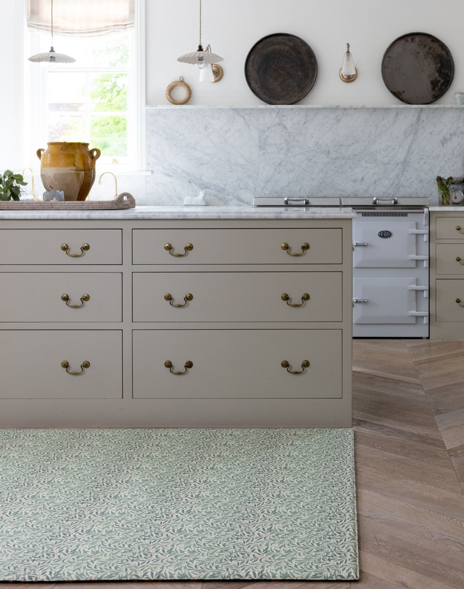 Beautiful family kitchen with Totter and Tumble play mat unrolled against kitchen island the ideal play space for children with a wipeable surface to ensure cleaning is simple